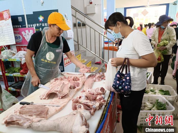资料图:海口市民在农贸市场购买肉类。张月和 摄 资料图:海口市民在农贸市场购买肉类。张月和 摄