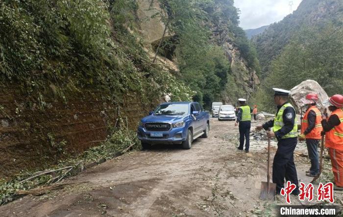 甘孜州公安交警等救援力量正在抢通地震中受损的道路，疏散车辆。甘孜州公安局供图
